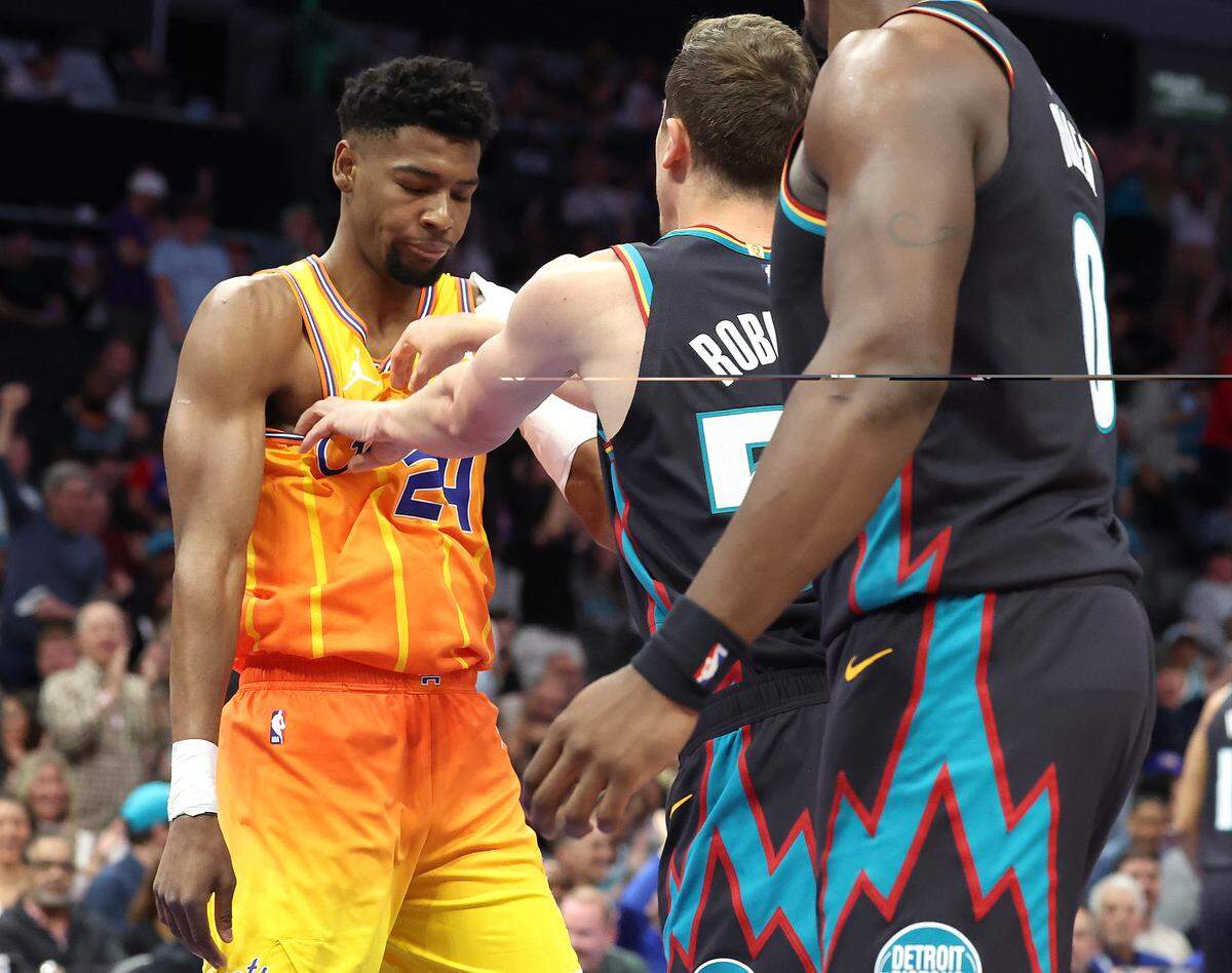 Detroit Pistons forward Duncan Robinson pushes Charlotte Hornets guard Brandon Miller, left, in the chest after Miller threw down a two-handed dunk during action at Spectrum Center in Charlotte, North Carolina on Friday, April 10, 2026.