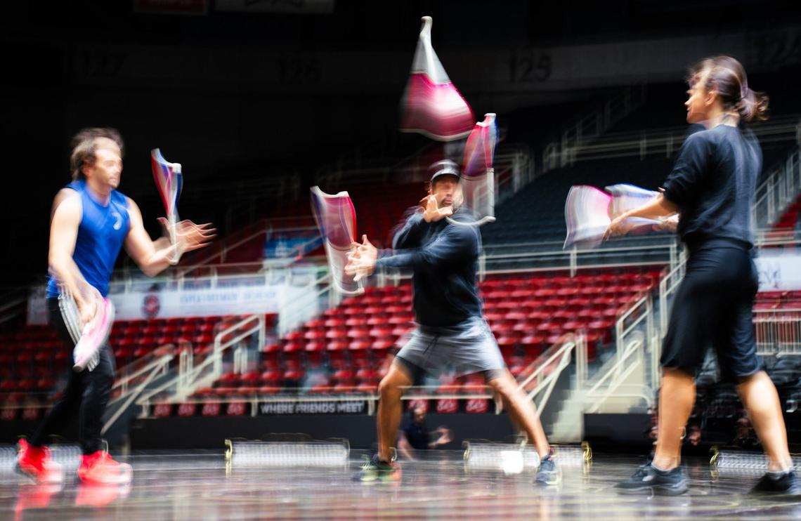 The Trio juggling team of Svetlana Zueva, Johan Juslin, and Fabio Luis Santos rehearse their skits during the Cirque Du Soleil’s CORTEO rehersal at the Bojangles Coliseum.