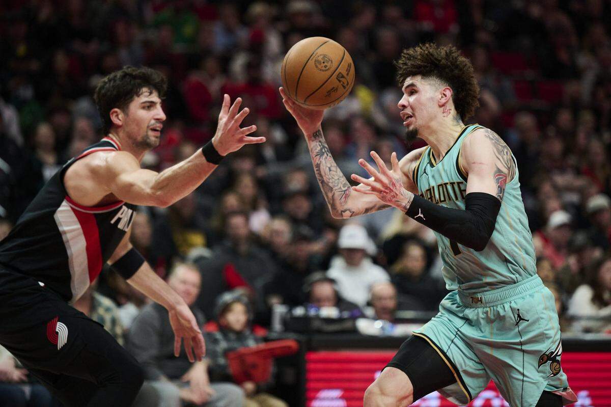 Charlotte Hornets guard LaMelo Ball (1) loses control of the basketball during the first half against Portland Trail Blazers forward Deni Avdija (8) at Moda Center.
