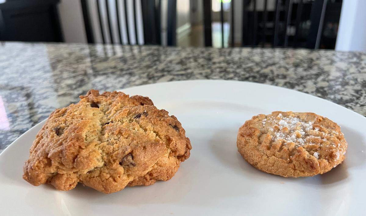 The “monster” chocolate chip cookie at Villani’s Bakery is shown next to a smaller peanut butter cookie.