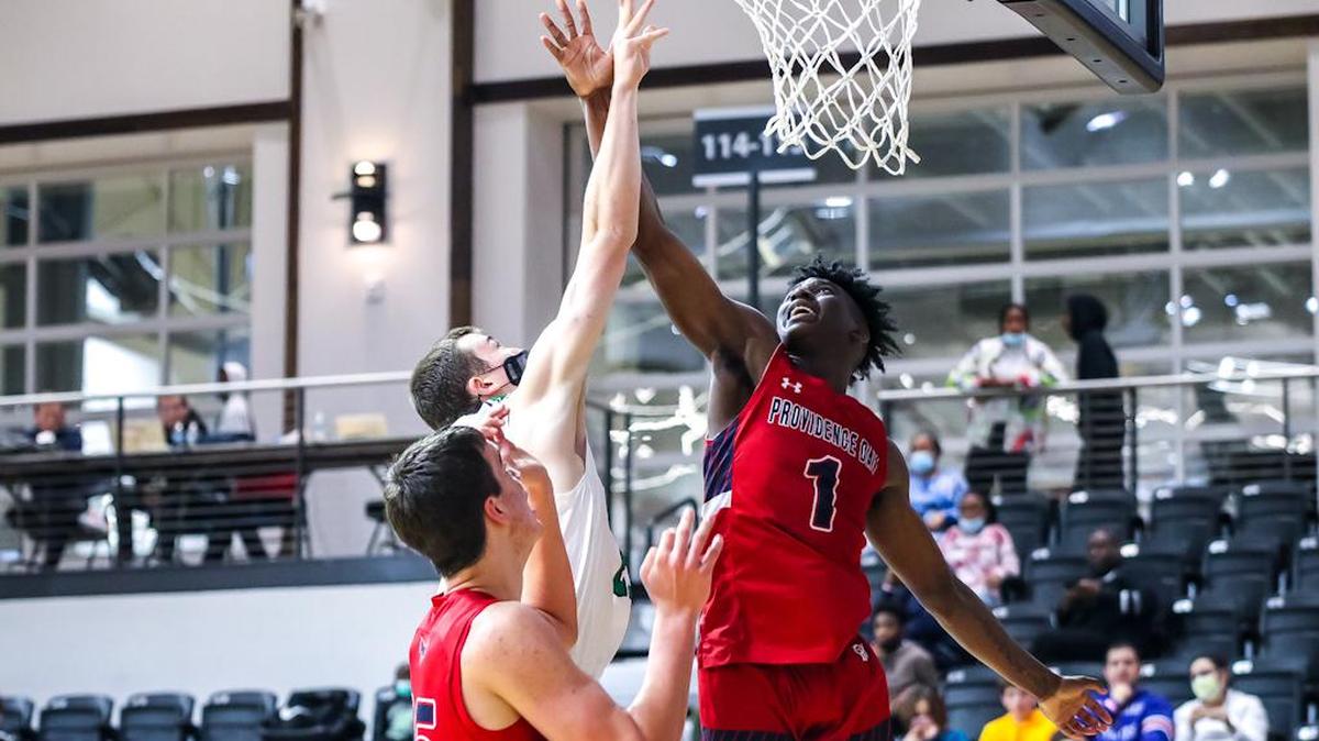 Weddington Player goes up for the layout as Providence Day tries to block the shot