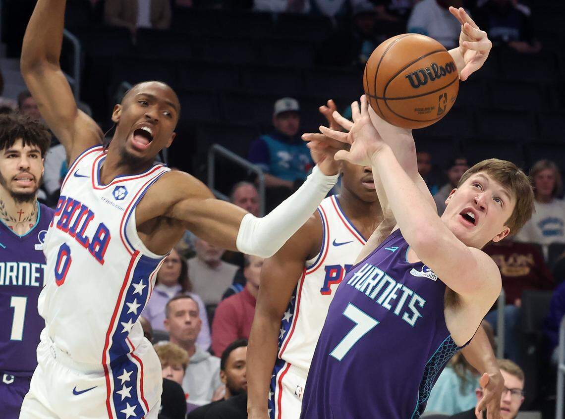 Charlotte Hornets forward Kon Knueppel, right, fights for control of a loose ball with Philadelphia 76ers guard Tyrese Maxey, left, during action at Spectrum Center in Charlotte, NC on Monday, January 26, 2026.