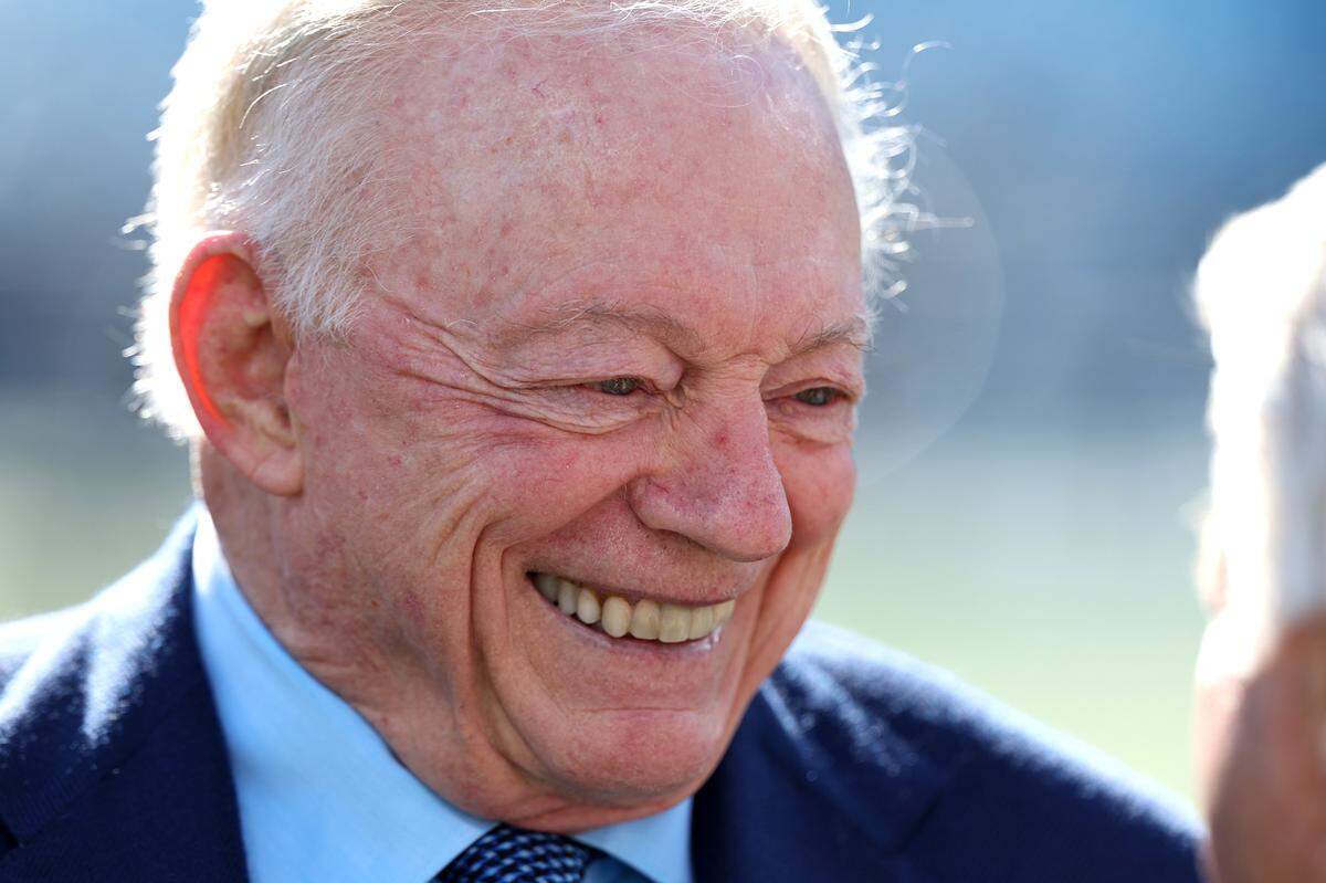 Dallas Cowboys owner Jerry Jones, left, enjoys time with former head coach Jimmy Johnson, right, during pregame activities on Sunday, November 19, 2023 at Bank of America Stadium.