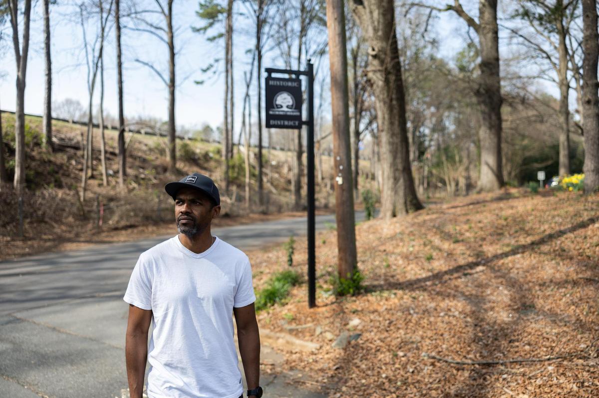 Sean Langley poses for a portrait where the highway backs up to the neighborhood of McCrorey Heights. A highway expansion project is threatening the neighborhood, but a historic designation may slow or stop the project.