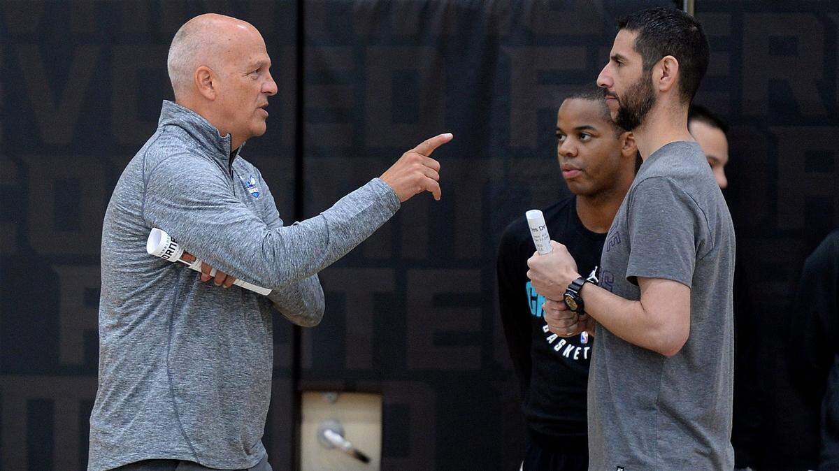 In this file photo, Hornets assistant coach Jay Triano (left) chats with head coach James Borrego.