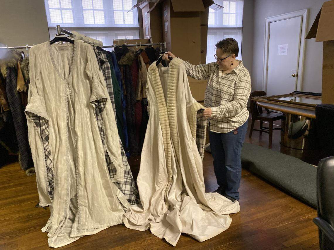 Opera Carolina costume coordinator Betsy Blackmore examines two costumes that will be worn by Lady Macbeth (a part performed by international opera singer Othalie Graham). Opera Carolina’s production runs Nov. 7, 9 and 10.