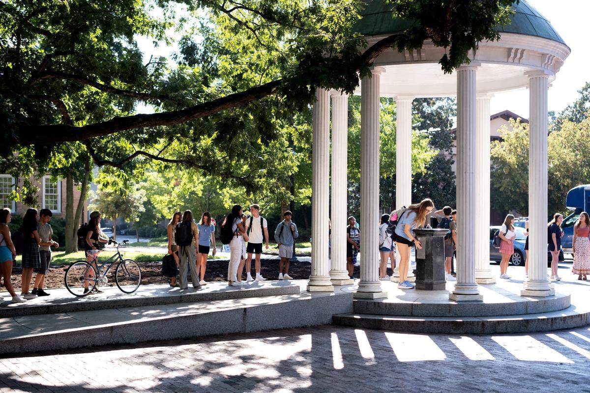 Students at The Old Well on UNC Chapel Hill’s campus. The public university is ranked No. 4 in top public schools and No. 16 in best value schools, according to U.S. News & World Report.