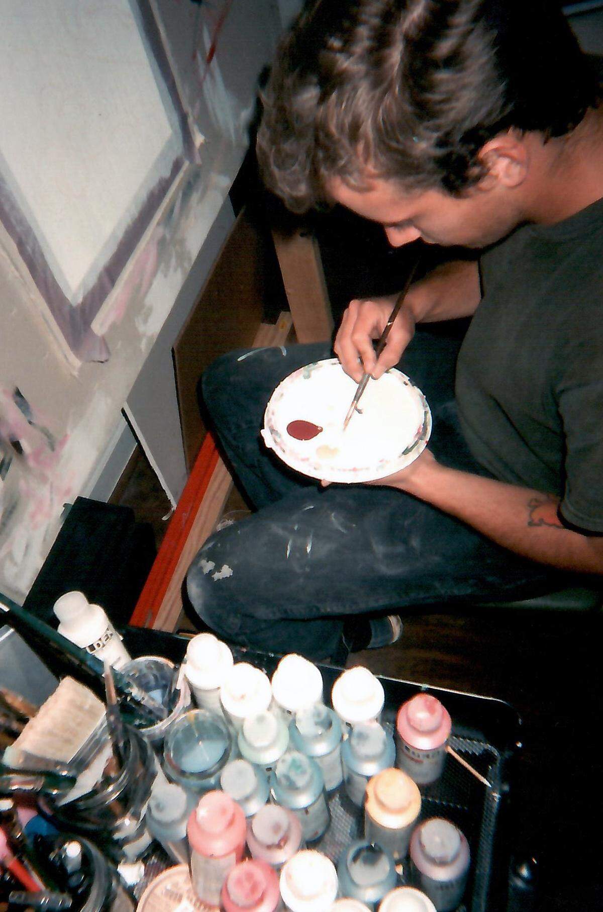 Charlotte artist Dustin Brown mixes paint in his studio.