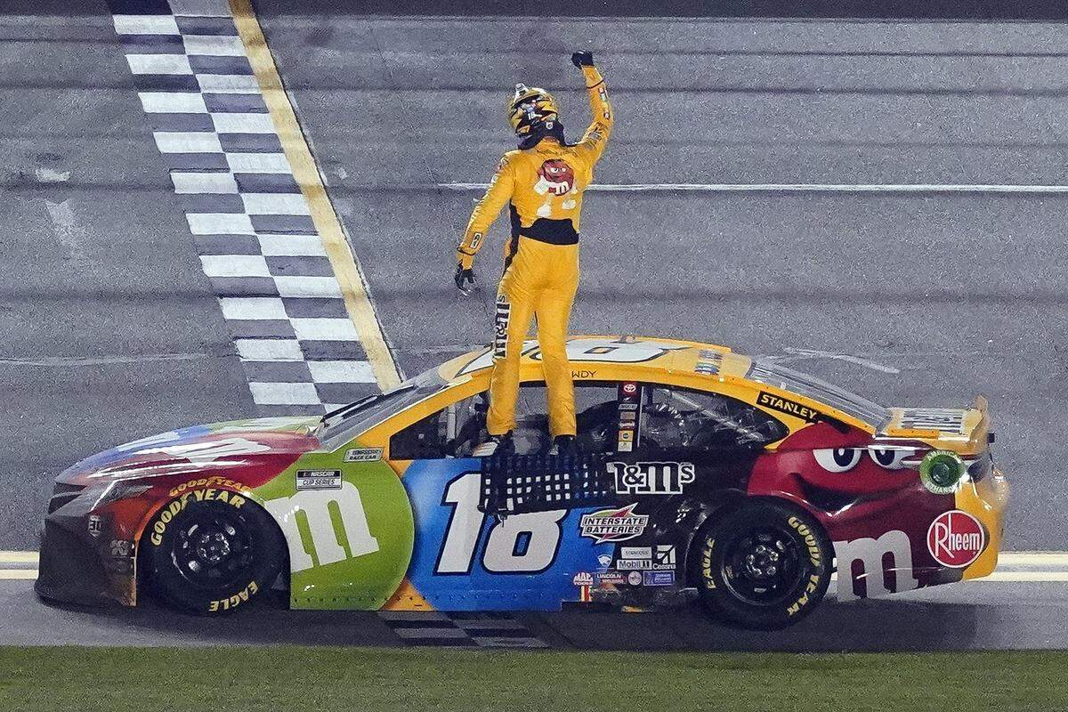 Kyle Busch celebrates on the top of his car after winning the NASCAR Clash auto race at Daytona International Speedway, Tuesday, Feb. 9, 2021, in Daytona Beach, Fla. (AP Photo/John Raoux)