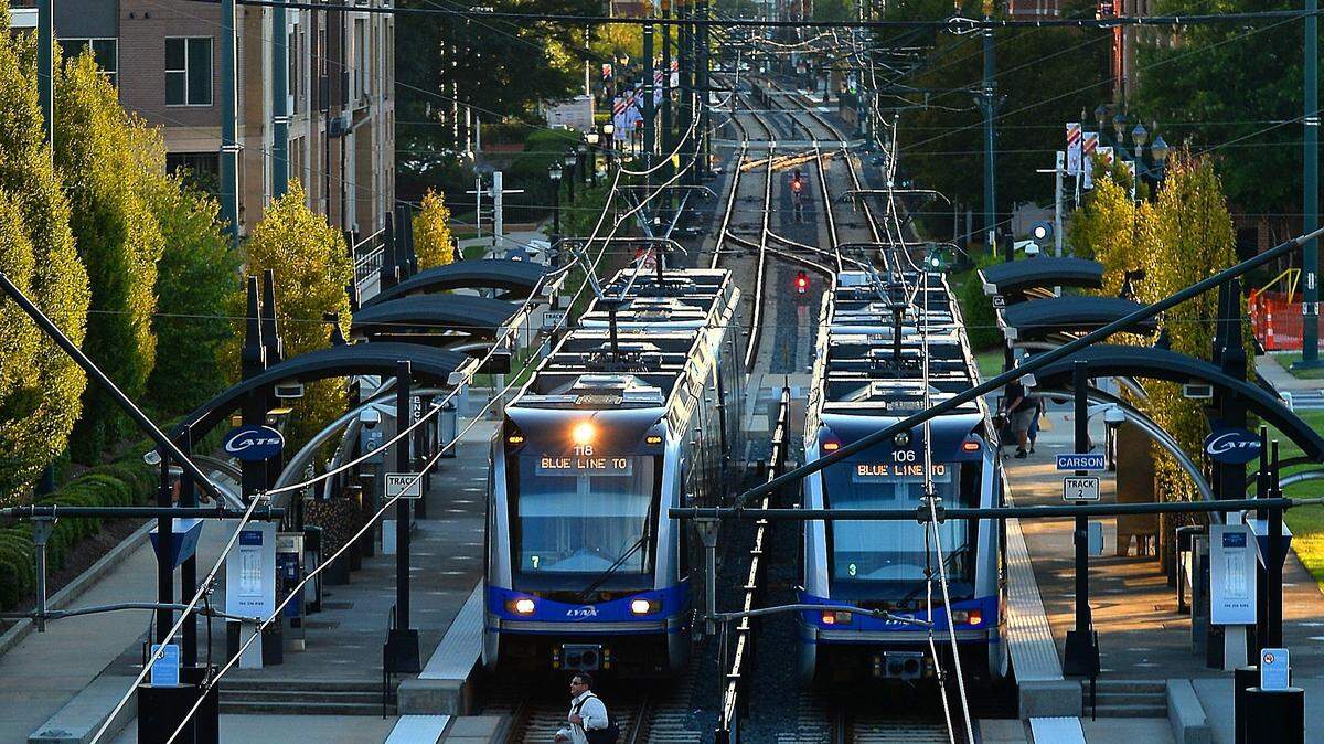 Two Lynx Blue Line trains are stopped at a South End light-rail station near uptown Charlotte.
