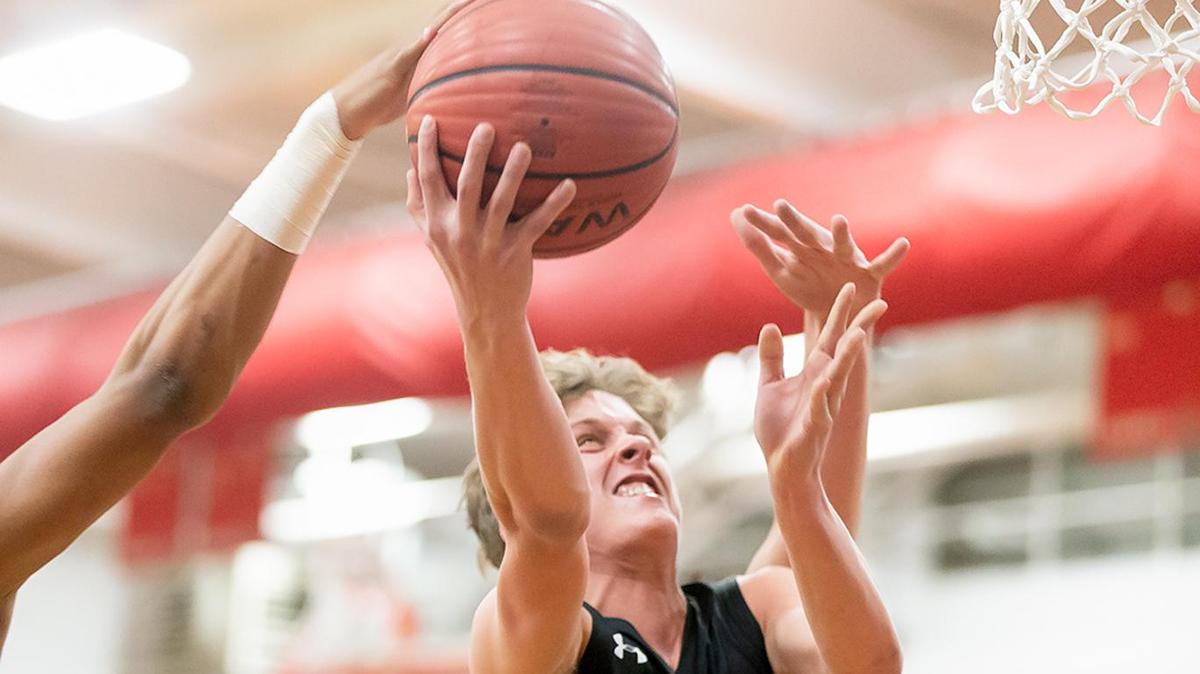 Ardrey Kell’s Luke Stankavich (11) drives the lane and is fouled during early 1st half action.