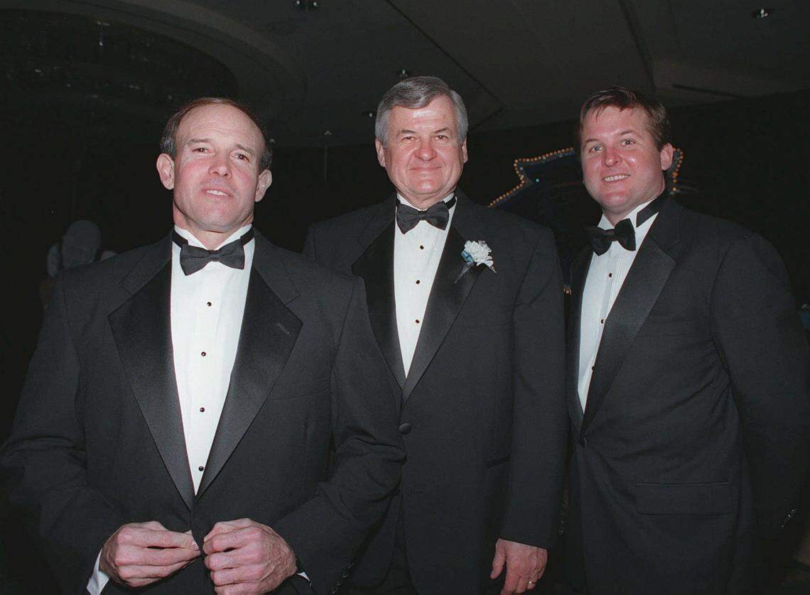3/02/96 4G Panthers coach Dom Capers (from left), Panthers owner Jerry Richardson and his son, Jon, director of stadium operations, salute one of their own, Panthers quarterback Kerry Collins, at a fund-raiser for the Juvenile Diabetes Association. The event was Feb. 26 at the Omni Hotel. (UNPUBLISHED NOTES:) (2/26/96) Dom Capers, Jerry Richardson, and Jon Richardson at the Diabetes Benefit at the Omni hotel.