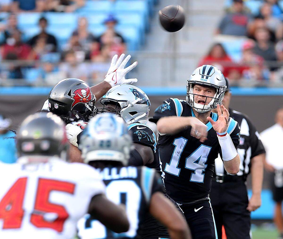 Carolina Panthers quarterback Sam Darnold, right, passes to a receiver over the Tampa Bay Buccaneers defense during fourth quarter action on Sunday, December 26, 2021 at Bank of America Stadium in Charlotte, NC. The Buccaneers defeated the Panthers 32-6.