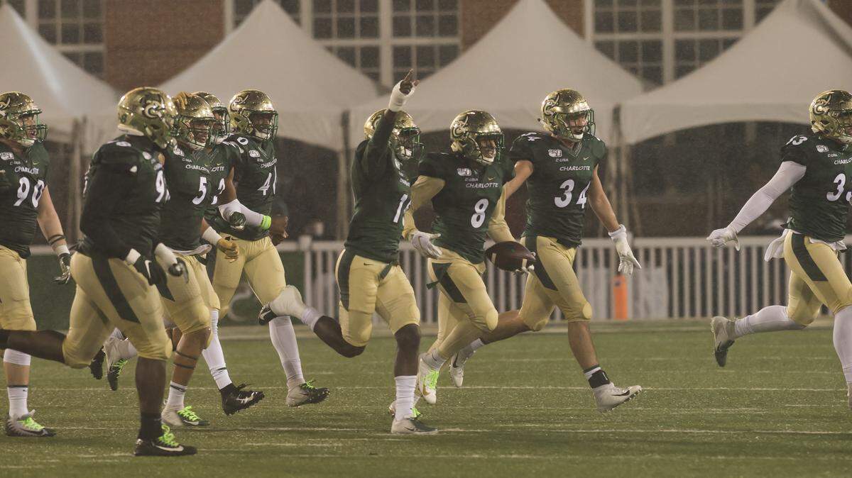 The Charlotte 49ers’ defense celebrates after an interception by Nafees Lyon (8) against Marshall on Saturday