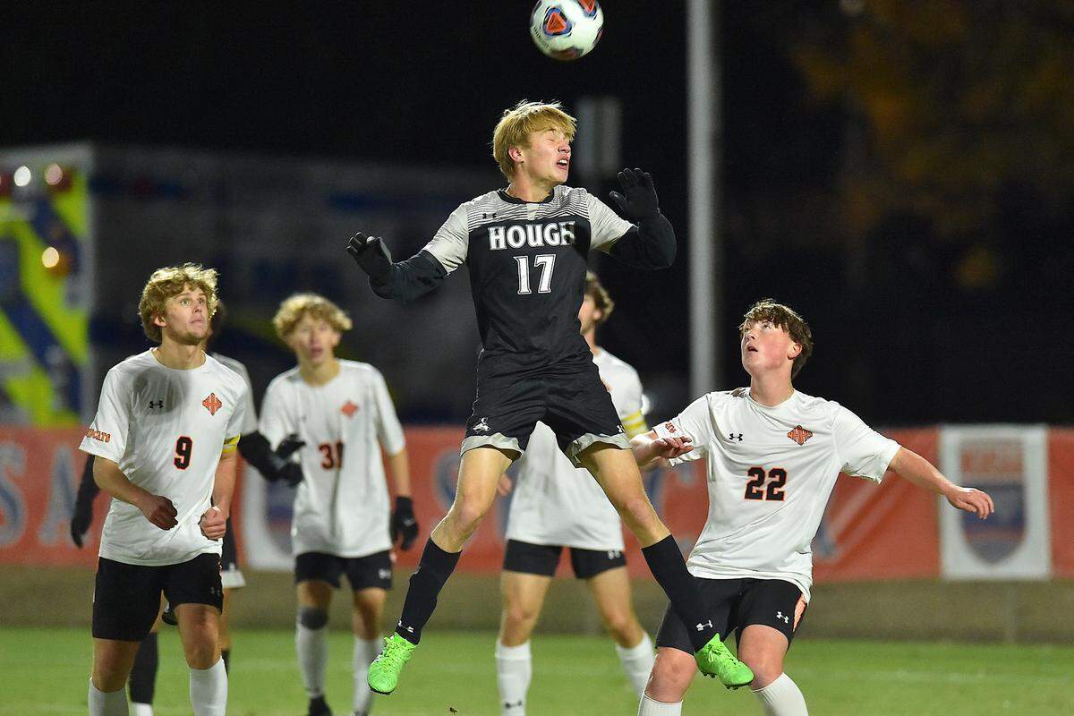 Hough’s Jedd Wagner (17) makes the header during the first half over New Hanover’s Owen Hayworth (22). The New Hanover Wildcats and the Hough Huskies met in the NCHSAA 4A Boys Soccer Championships in Cary, N.C. on November 20, 2021.
