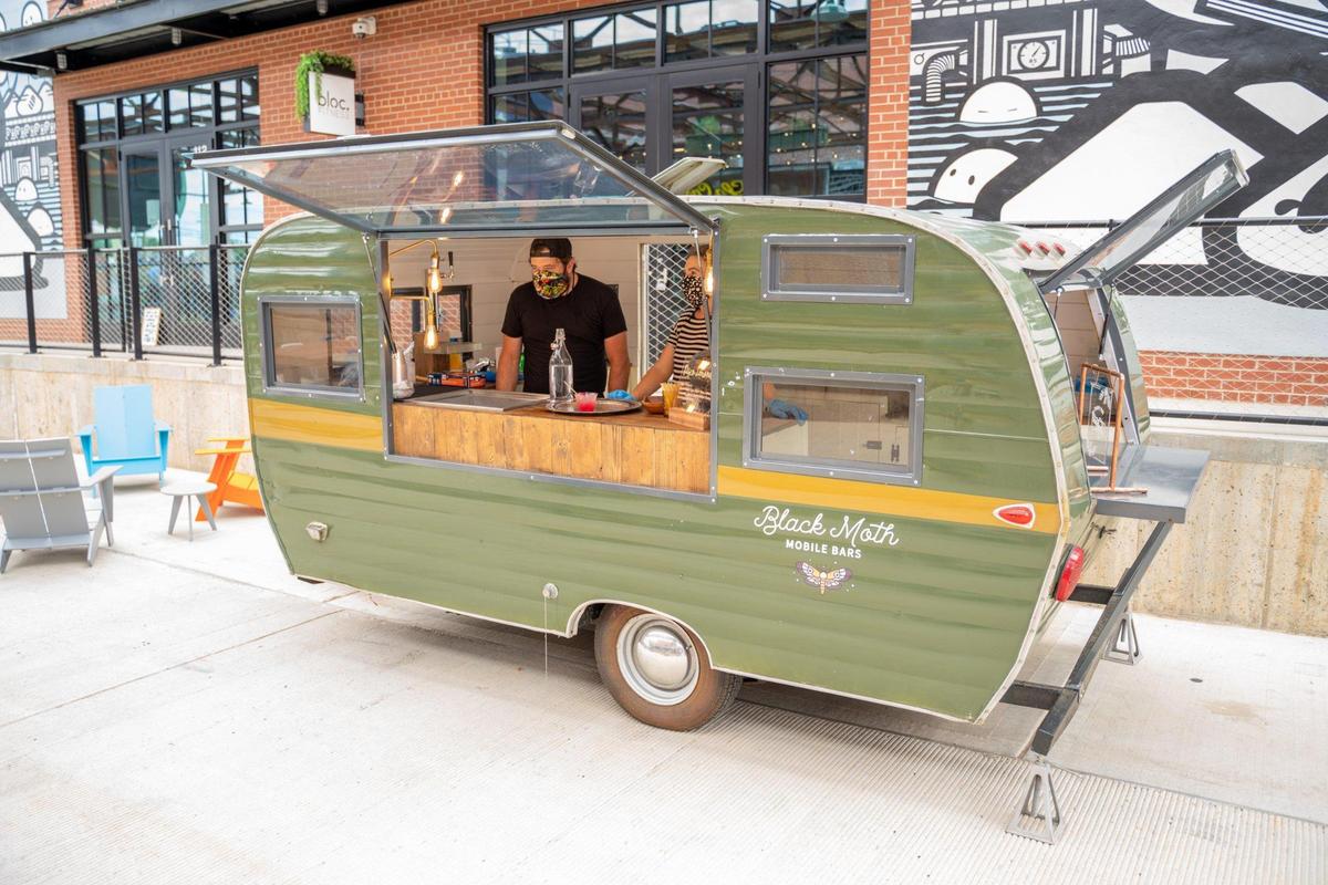 James Little and Rachel Hopkins of Black Moth Mobile Bars are welcoming visitors to Camp North End during a preview of the Keswick Avenue food stalls.