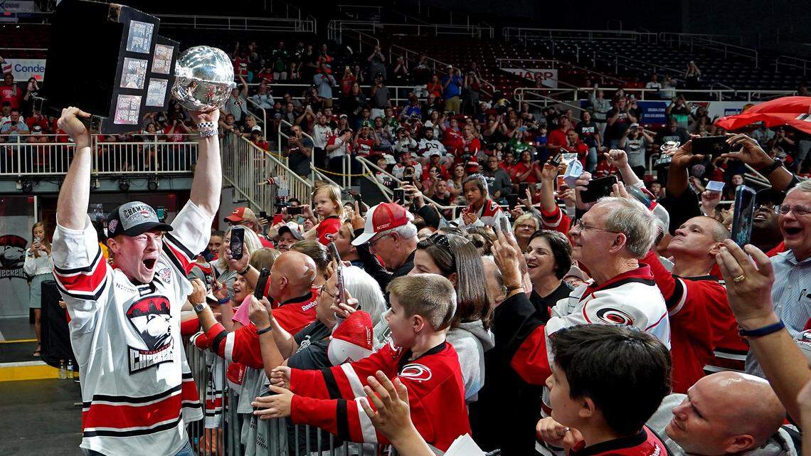 Charlotte Checkers team captain and forward Patrick Brown yells as he carries the Calder Cup to the cheers of fans during the team’s celebration for defeating the Chicago Wolves and winning the Calder Cup on Saturday, June 8, 2019. The team’s celebration was held at Bojangles’ Coliseum in Charlotte, NC on Monday, June 10, 2019.