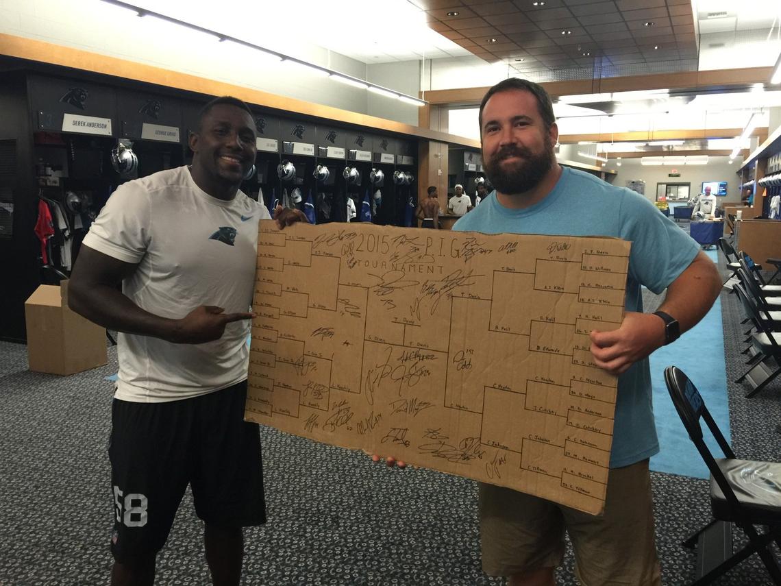 Thomas Davis (left) poses with Ryan Kalil, the Panthers center and PIG commissioner, after Davis won the event in 2015. Like all other winners, Davis got to keep the bracket at the end of the tournament. “The best thing that you can get if you’re a Carolina Panther is the PIG bracket,” says Luke Kuechly, who never won one.