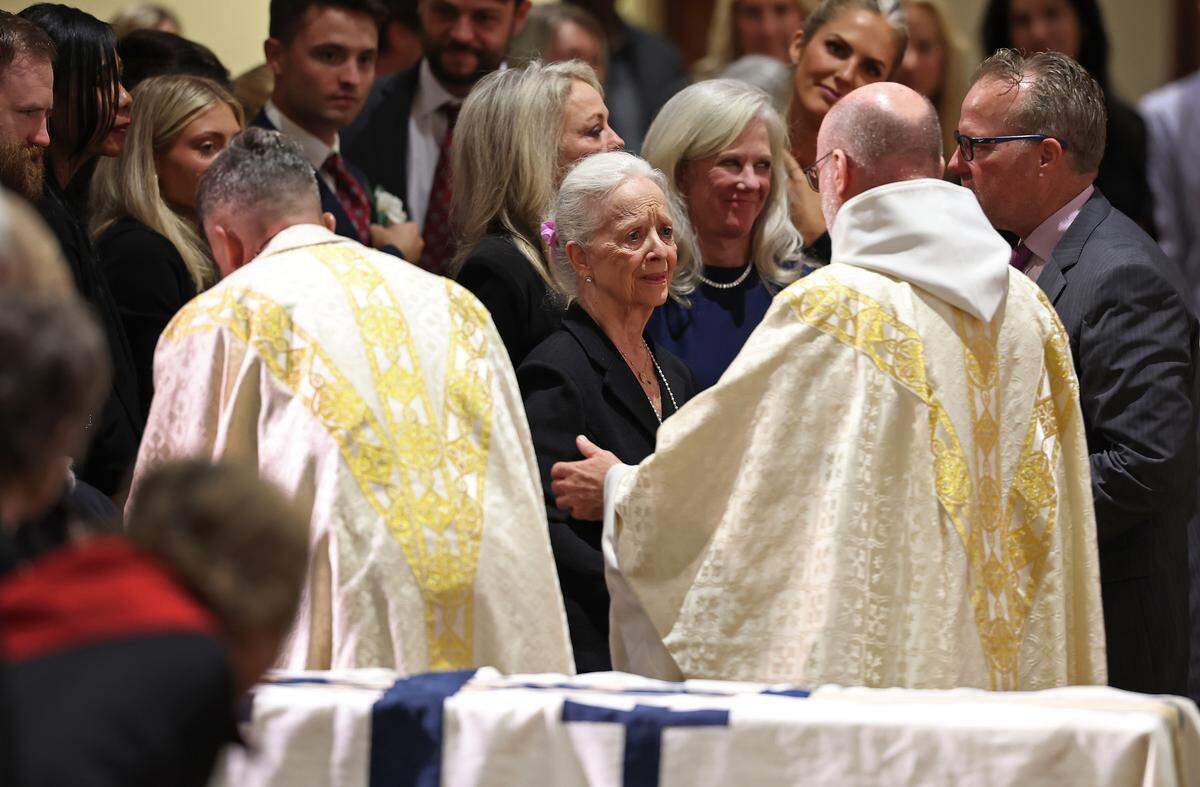 Abbot Placid Solari, a Benedictine monk, right, comforts Pat Wheeler, center, during the funeral for her husband, H.A. “Humpy” Wheeler Jr., the former Charlotte Motor Speedway president at St. Gabriel Catholic Church in Charlotte. Abbot Solari is Abbot of Belmont Abbey and Chancellor of Belmont Abbey College.