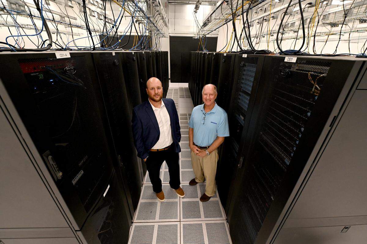 Chris Allgauer, Segra's senior director data centers, left and data center manager Glenn Palehonki, right, at the company's CLT 2 data center on Monday, October 27, 2025.