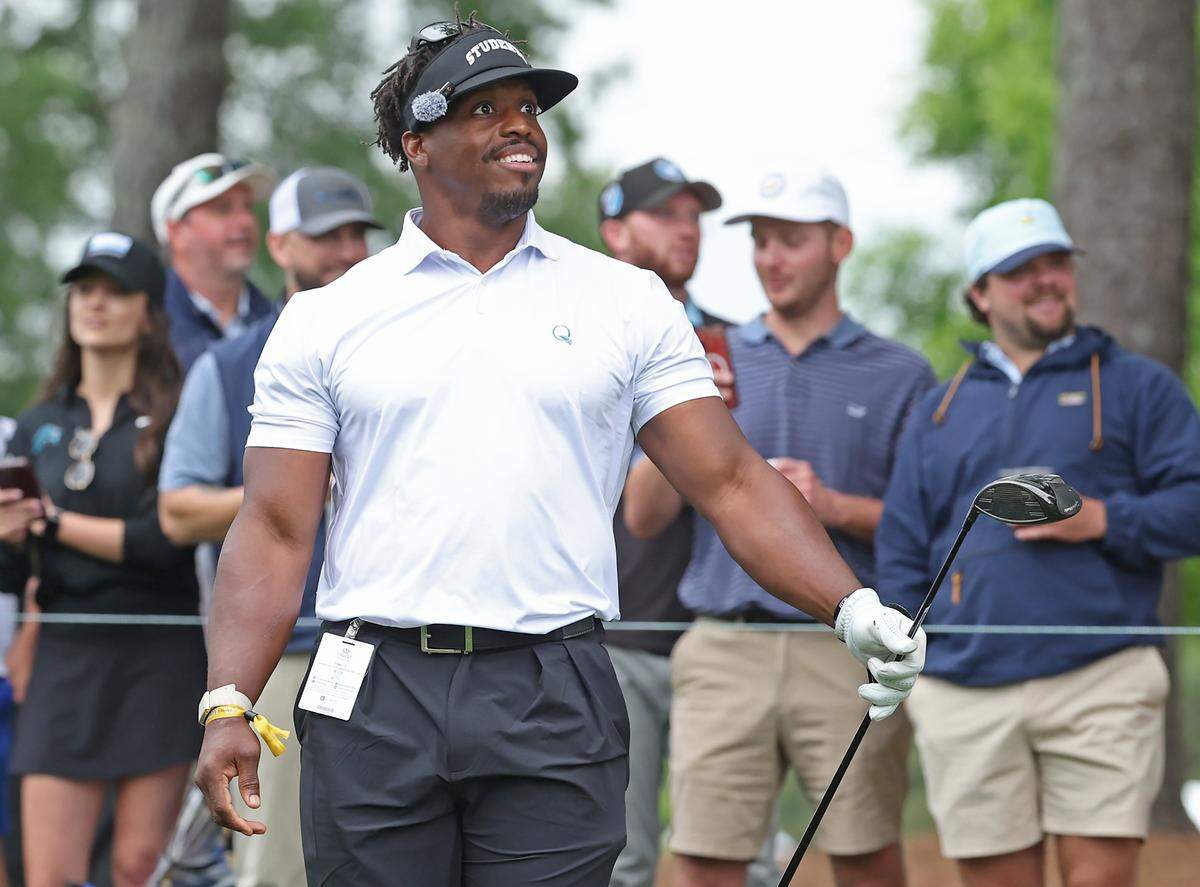 Former Carolina Panthers running back Jonathan Stewart smiles as he watches his drive from the first tee box during the Truist Championship Pro-Am at Quail Hollow Club in Charlotte, NC on Wednesday, May 6, 2026.