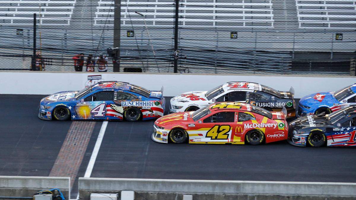 Kevin Harvick (4) leads the field on a restart in overtime of a NASCAR Cup Series auto race at Indianapolis Motor Speedway in Indianapolis, Sunday, July 5, 2020. (AP Photo/Darron Cummings)
