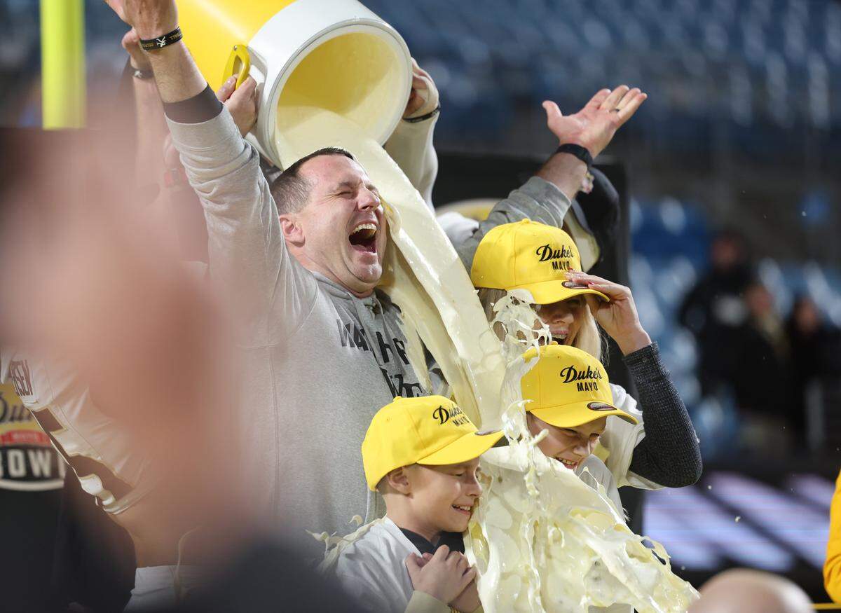 Wake Forest University head football coach Jake Dickert and his family is dumped with Duke's Mayonnaise Friday, Jan. 2, 2025 after the Duke Mayo Bowl at Bank of America Stadium.