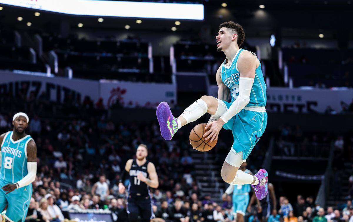 Charlotte Hornets LaMelo Ball prepares to throw an alley-oop pass to Montrezl Harrell off the backboard against Orlando Thursday night.