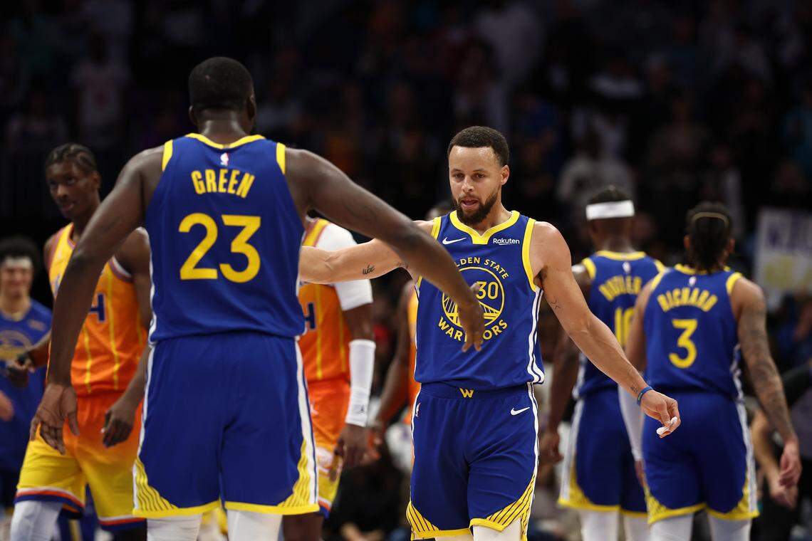CHARLOTTE, NORTH CAROLINA - DECEMBER 31: Draymond Green #23 and Stephen Curry #30 of the Golden State Warriors react during the fourth quarter of the game against the Charlotte Hornets at Spectrum Center on December 31, 2025 in Charlotte, North Carolina. NOTE TO USER: User expressly acknowledges and agrees that, by downloading and or using this photograph, User is consenting to the terms and conditions of the Getty Images License Agreement. (Photo by Jared C. Tilton/Getty Images)