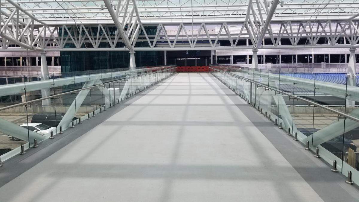 Charlotte Douglas International Airport unveiled two skybridges Monday linking the hourly deck and terminal as part of the terminal lobby expansion project.