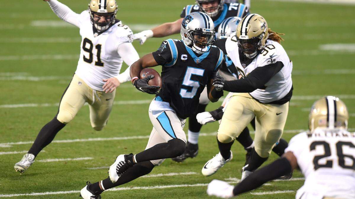Carolina Panthers quarterback Teddy Bridgewater, center, rushes for yardage inside the red zone during first quarter action against the New Orleans Saints at Bank of America Stadium on Sunday, January 3, 2021.