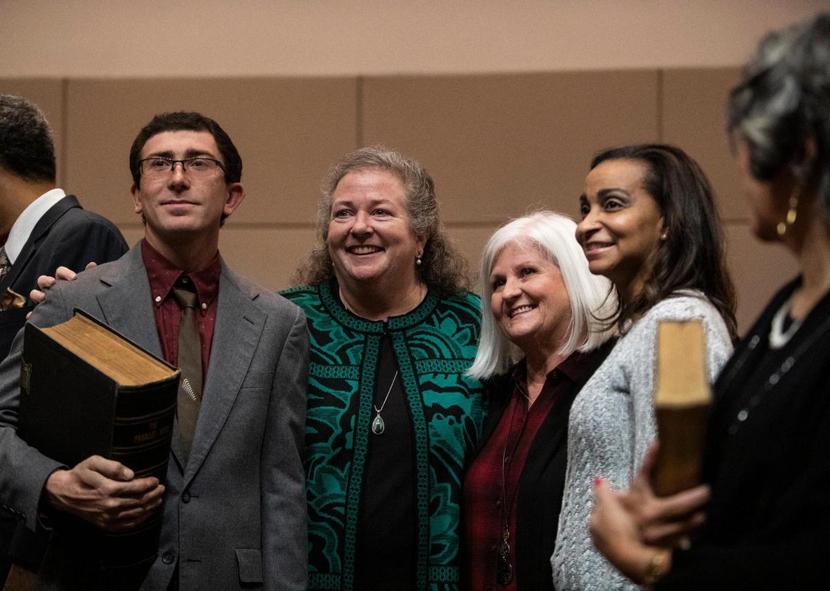 Commissioner Elaine Powell, of District 1, stands with her family at the Charlotte-Mecklenburg Government Center Monday, Dec. 5 in Charlotte, NC.