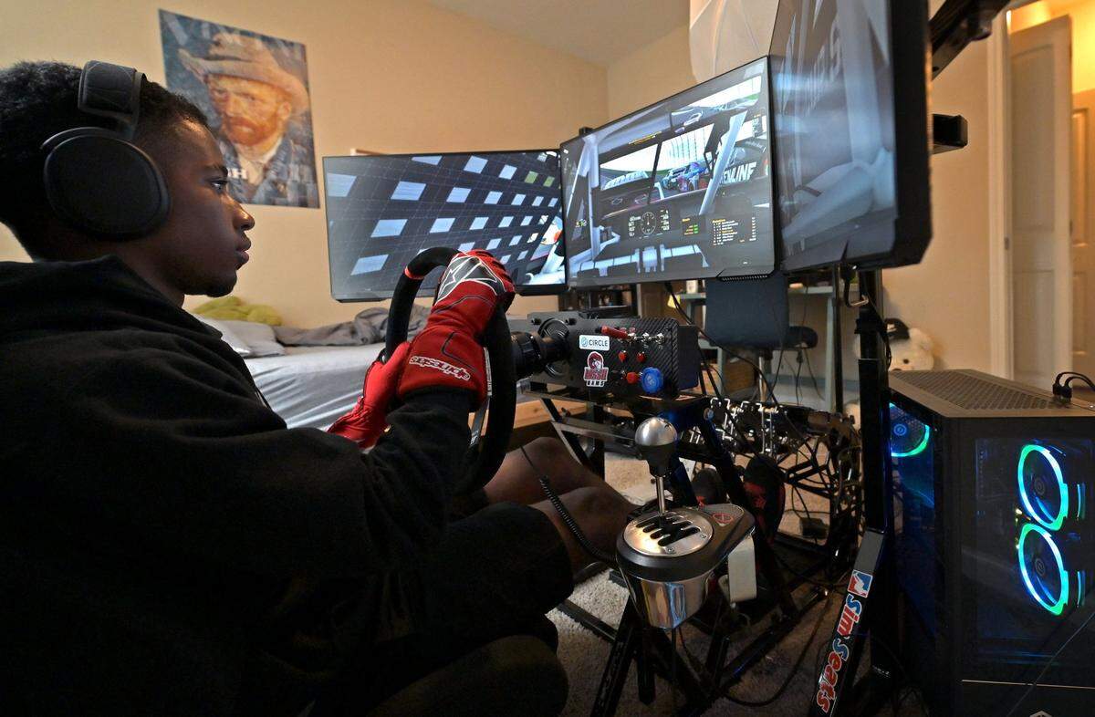 NASCAR driver Rajah Caruth uses his iRacing simulator in his apartment bedroom to compete in a race at Atlanta Motor Speedway on Friday, July 1 2022.