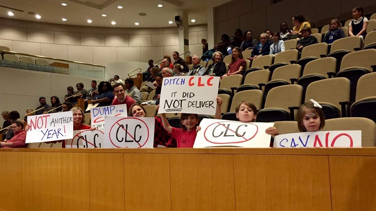 Families who wanted to see Bruns Academy switch from a continuous learning calendar, or CLC, to a traditional late August start date showed up with signs at Tuesday’s school board meeting.