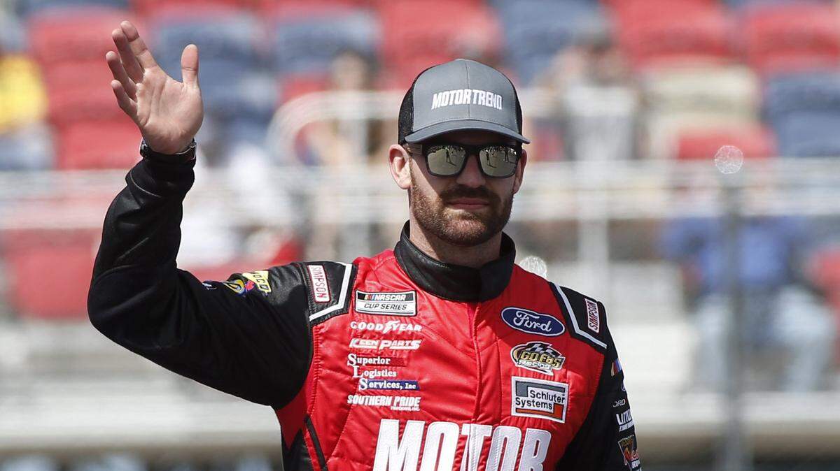 Corey LaJoie waves to fans during driver introductions prior to the NASCAR Cup Series auto race at Phoenix Raceway, Sunday, March 8, 2020, in Avondale, Ariz. (AP Photo/Ralph Freso)
