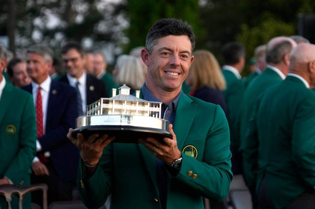 Rory McIlroy celebrates with the trophy after winning the Masters Tournament at Augusta National Golf Club.