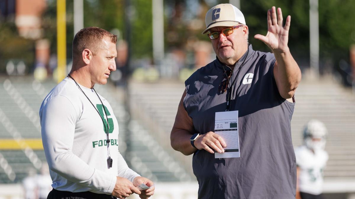 Charlotte 49er’s Football head coach Biff Poggi speaks with the Director of Strength and Conditioning coach Lewis Caralla ahead of their final intrasquad game at Jerry Richardson Stadium Saturday August 24, 2024.