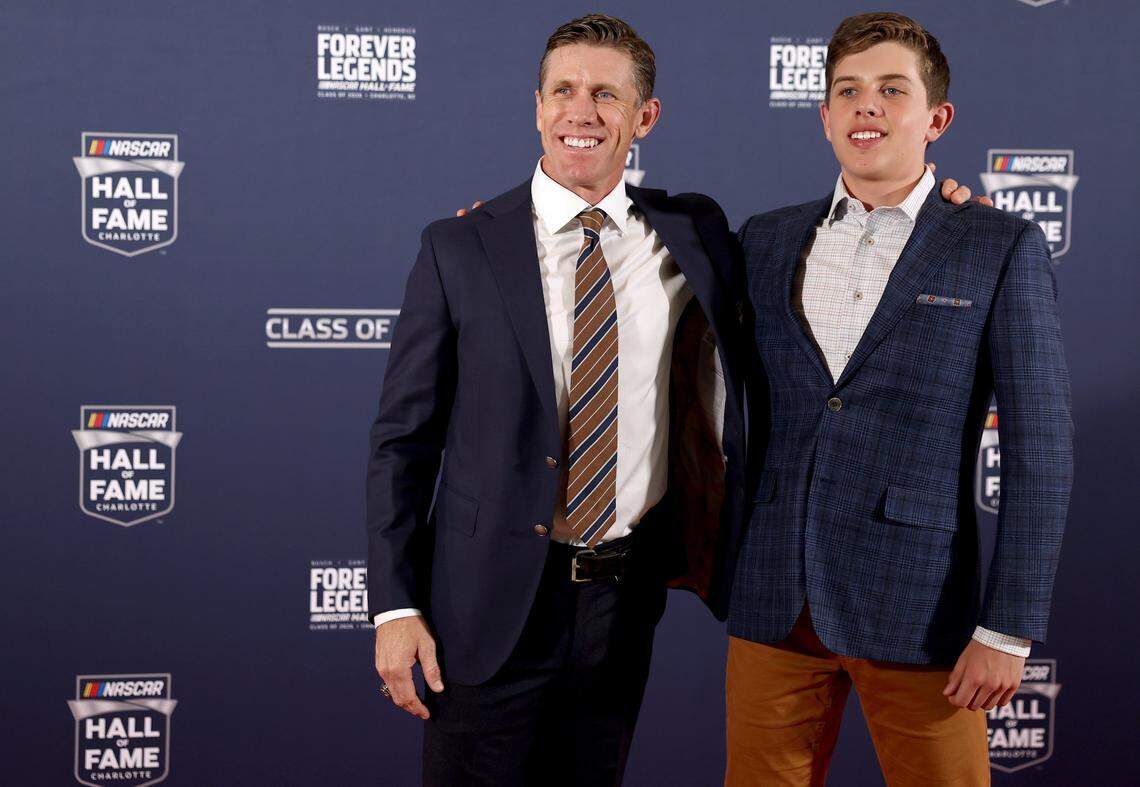 Former NASCAR driver Carl Edwards, left, poses for photographs on the red carpet with his son, Michael at the NASCAR Hall of Fame on Friday, January 23, 2026.