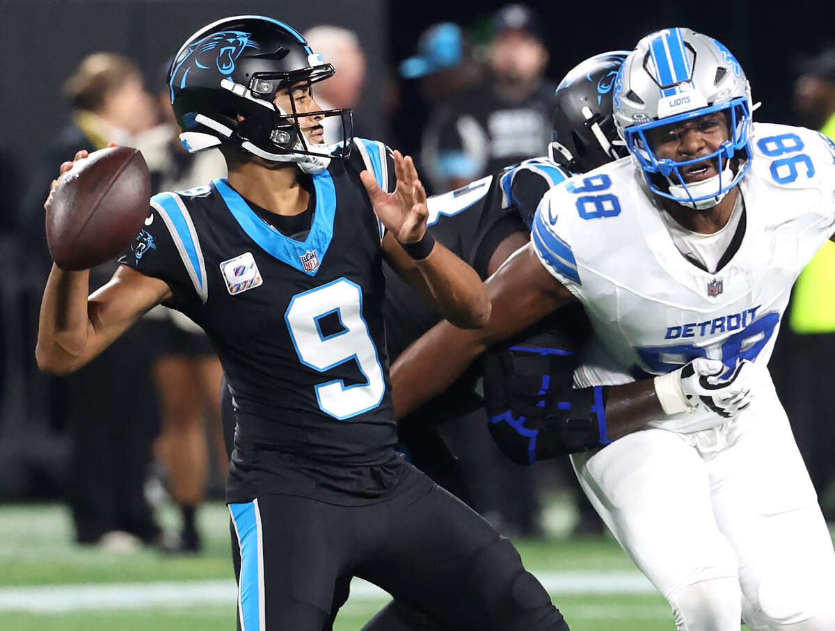 Carolina Panthers quarterback Bryce Young, left, drops back to pass as the Detroit Lions’ D.J. Wonnum, right, rushes during action at Bank of America Stadium in Charlotte, NC on Sunday, October 4, 2026.
