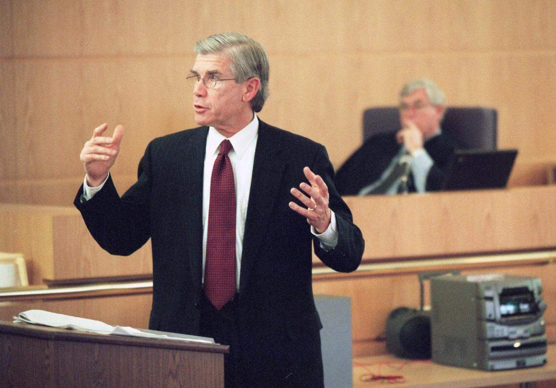 Prosecutor Gentry Caudill, left, says a moment he experienced with Saundra Adams and her family after the verdict in the death of her daughter was “incredibly moving.” Caudill would become a judge himself shortly after the Rae Carruth trial ended.