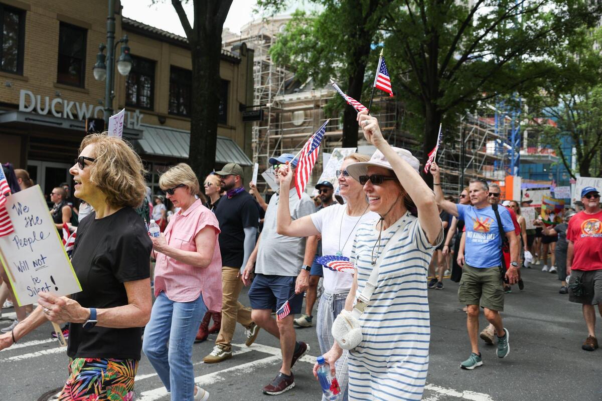 Protesters march during the No Kings protest along Tryon Street in Charlotte Saturday, June 14, 2025.