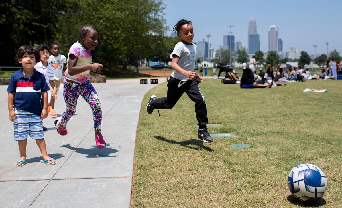Students from Elizabeth Traditional Elementary School play soccer during the school’s picnic celebrating the last day of school at Independence Park on Friday, June 9, 2023.