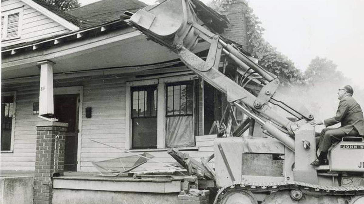 In 1958 a bulldozer pushes over the first house in Brooklyn, a once-thriving Black community in uptown Charlotte, to make way for so-called urban renewal. At an Aug. 10, 2020 Charlotte City Council meeting Mayor Vi Lyles acknowledged city policies that “impeded the stability, the well-being and progress” of Black residents and apologized for the city’s role in systemic racism.