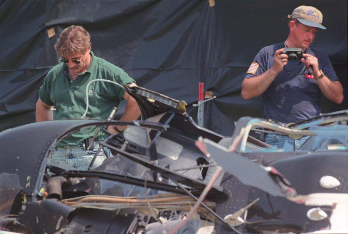 In this May 1998 file photo, Paul Coombes, director of maintenance for U.S. Helicopters in Marshville, at left, and National Transportation Safety Board investigator Butch Wilson examine the wreckage of a Bell JetRanger helicopter that had crashed on U.S. 74, killing five people.