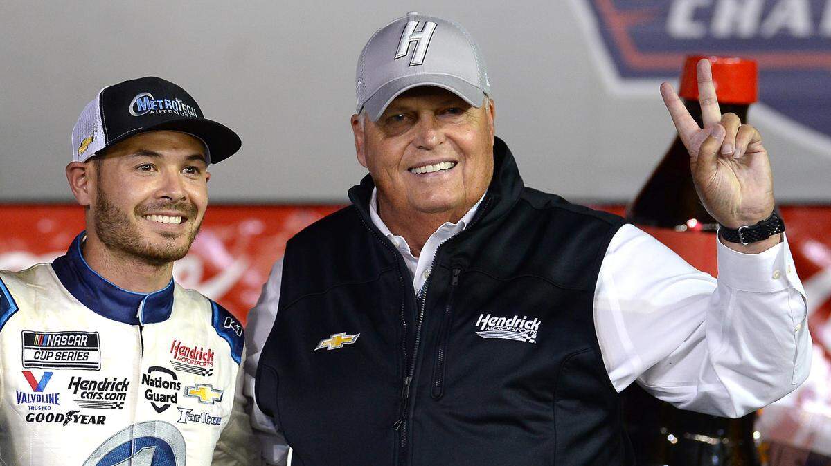 NASCAR driver Kyle Larson, left and team owner Rick Hendrick, right, celebrate winning the Coca-Cola 600 at Charlotte Motor Speedway in Concord in 2021.