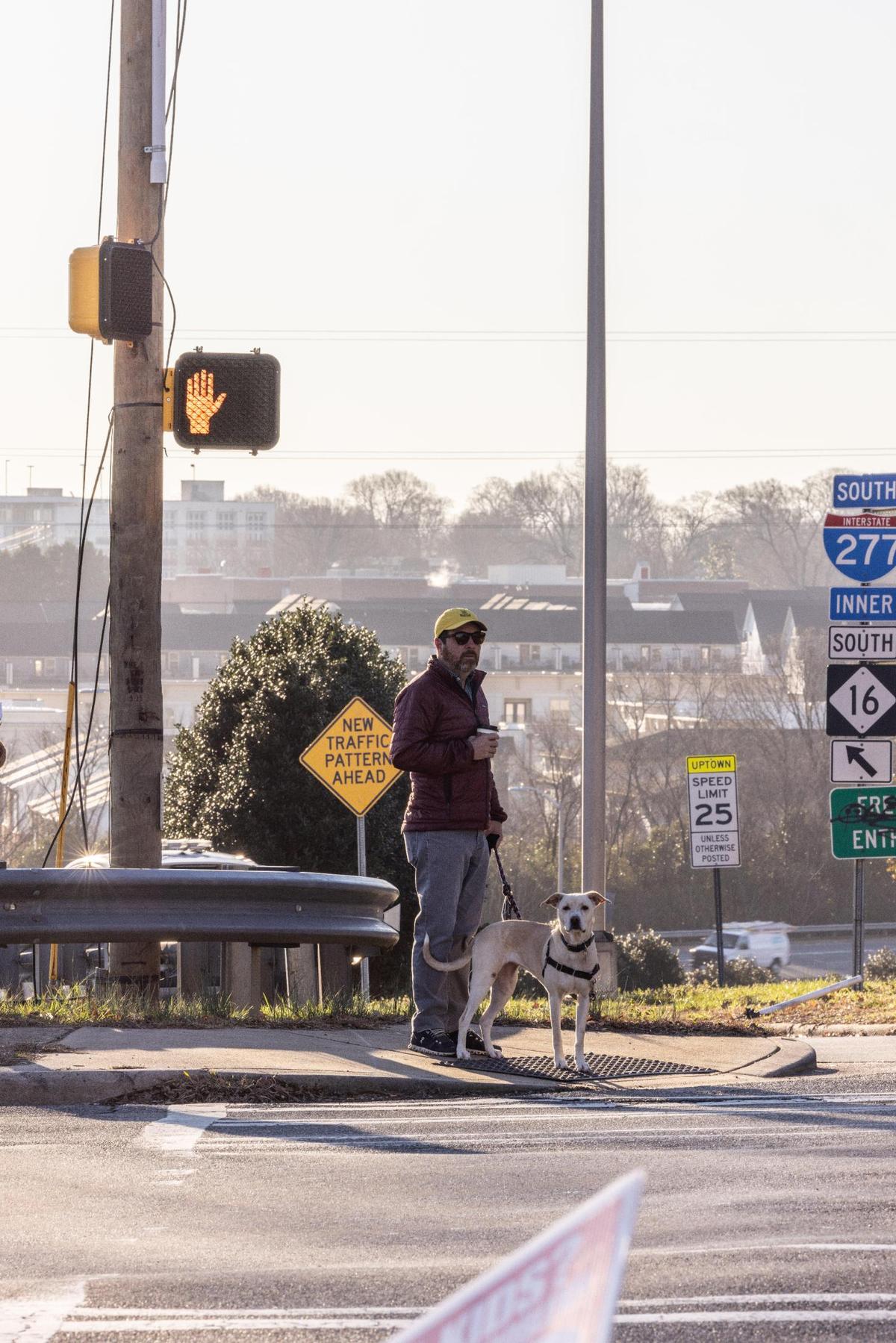 Graham Stevens waits to cross North Davidson Street at 11th street in Charlotte, N.C., on Monday, February 6, 2023.