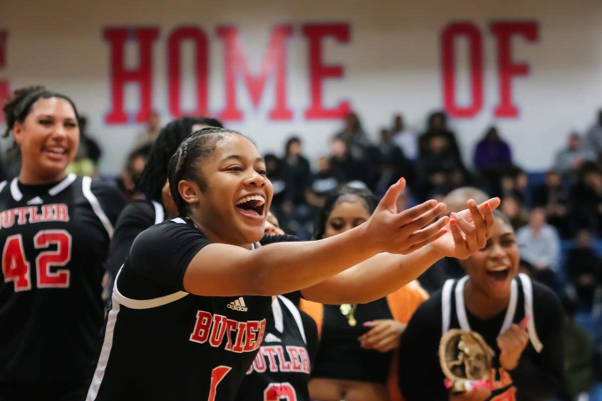 Players from Butler High School celebrate Friday’s Southwestern 4A tournament championship win Friday.