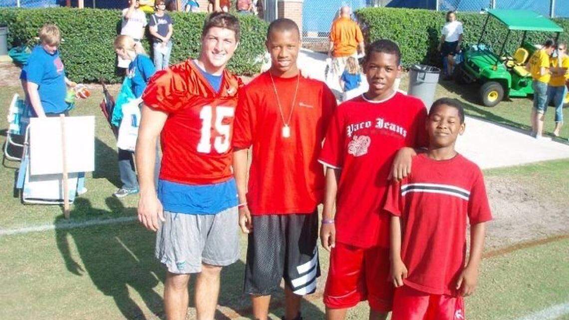 Former Florida quarterback Tim Tebow (left) with the LeMay brothers -- Christian (second from left), Uriah and Benny (right). PHOTO COURTESY LEMAY FAMILY.
