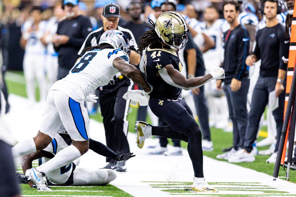 New Orleans Saints running back Alvin Kamara (41) runs against Carolina Panthers cornerback Jaycee Horn (8) during the first half at Caesars Superdome.