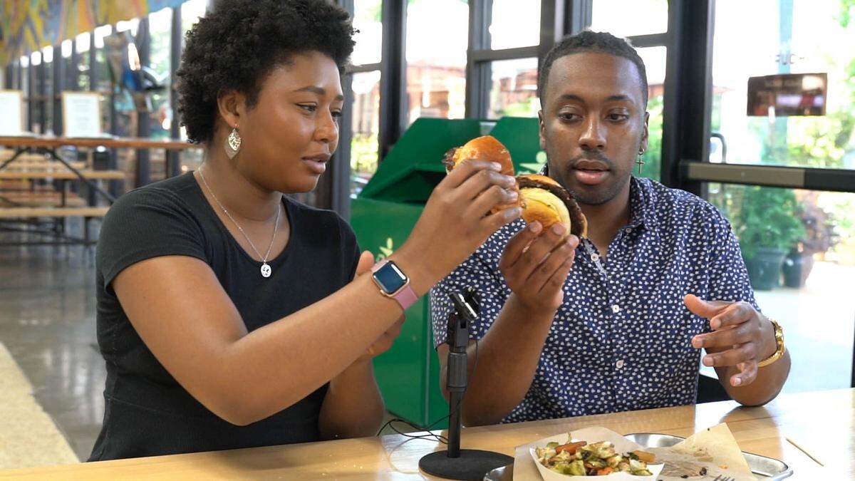 Lorenza Medley and Jonathan Alexander toast burgers at The Barcelona Burger & Beer Garden in Mooresville.